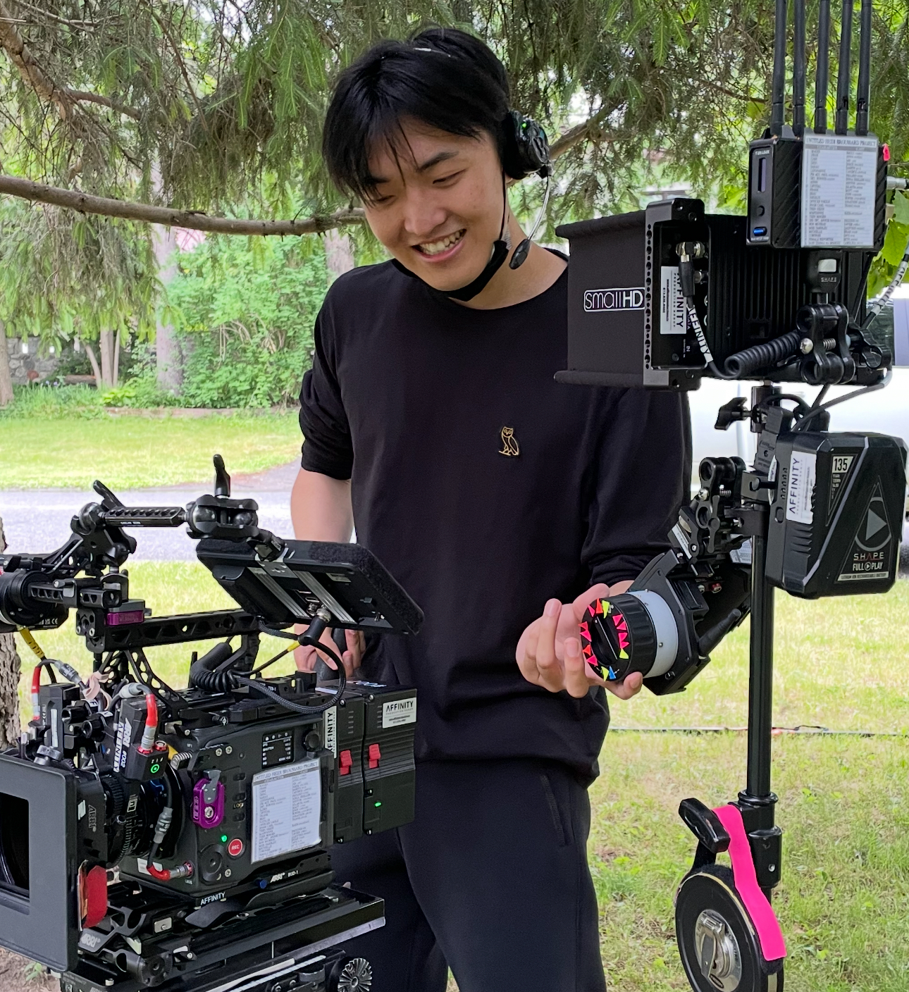 Boyi Tan adjusting camera gear during an outdoor shoot
