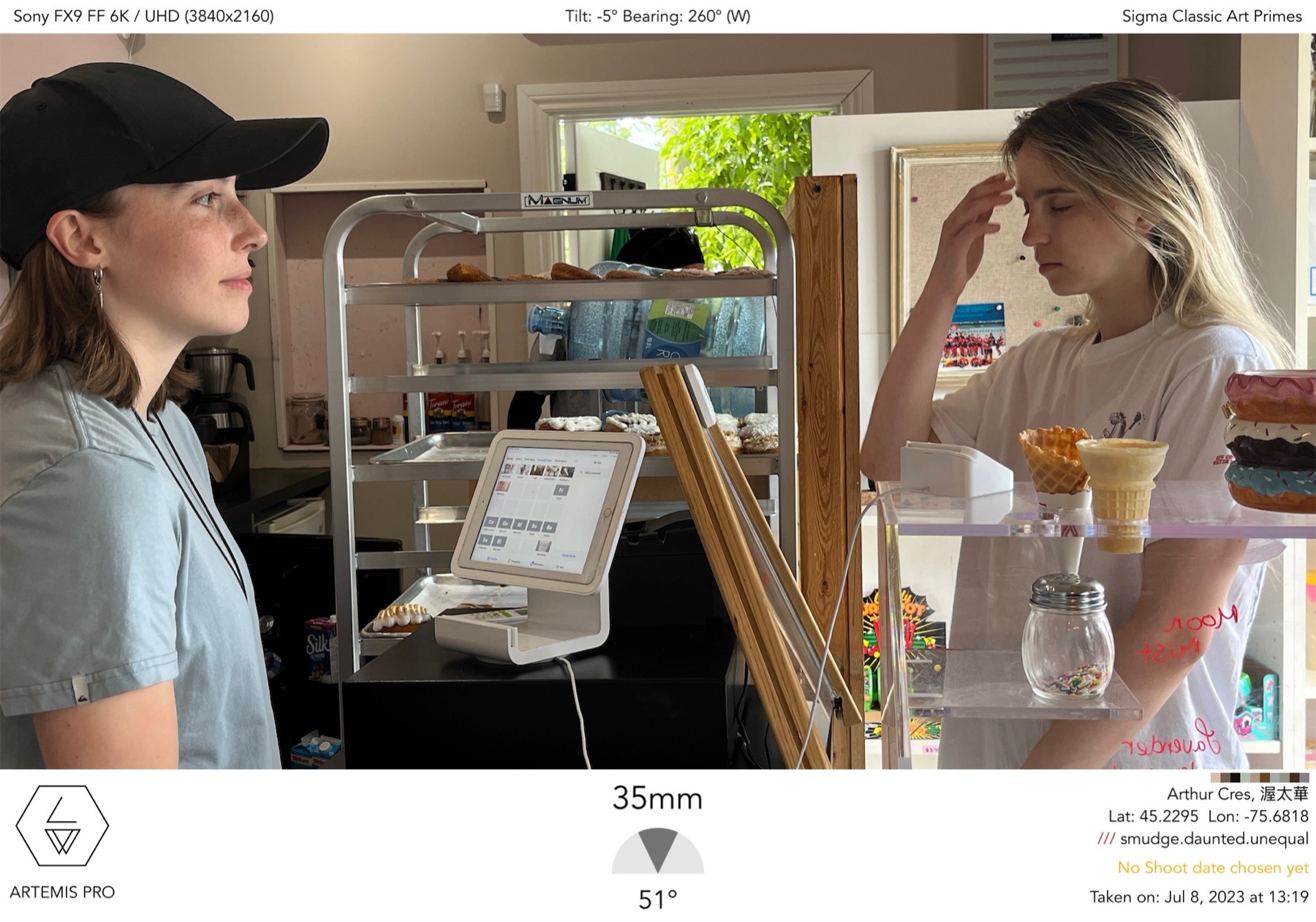 Done Before bakery interior scene reference showing actors positioned across the counter